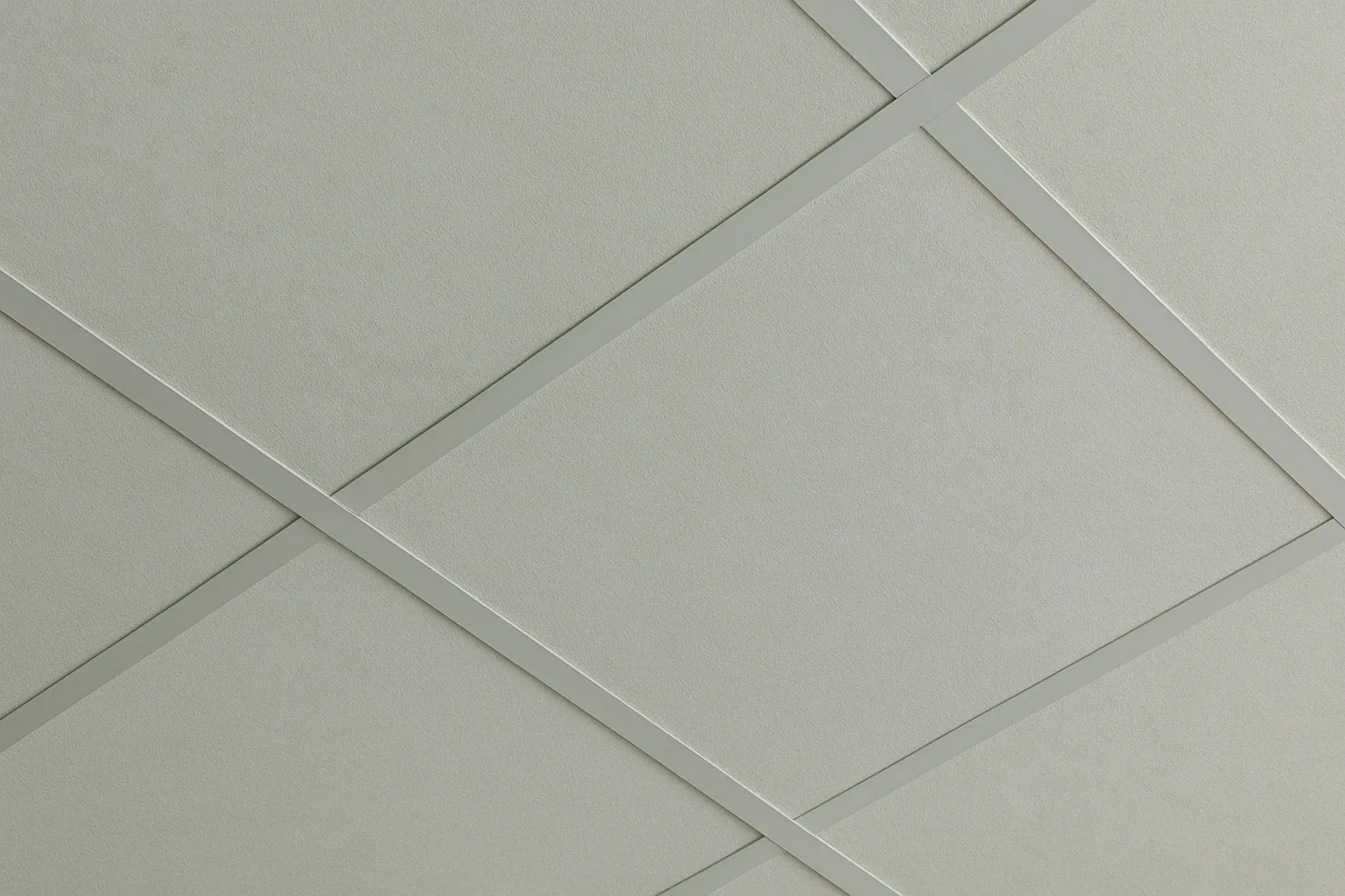 A close-up view of Aid Acoustics ceiling panels arranged in a grid layout, featuring soft-textured surfaces and sleek metal trim for both acoustic performance and architectural precision.