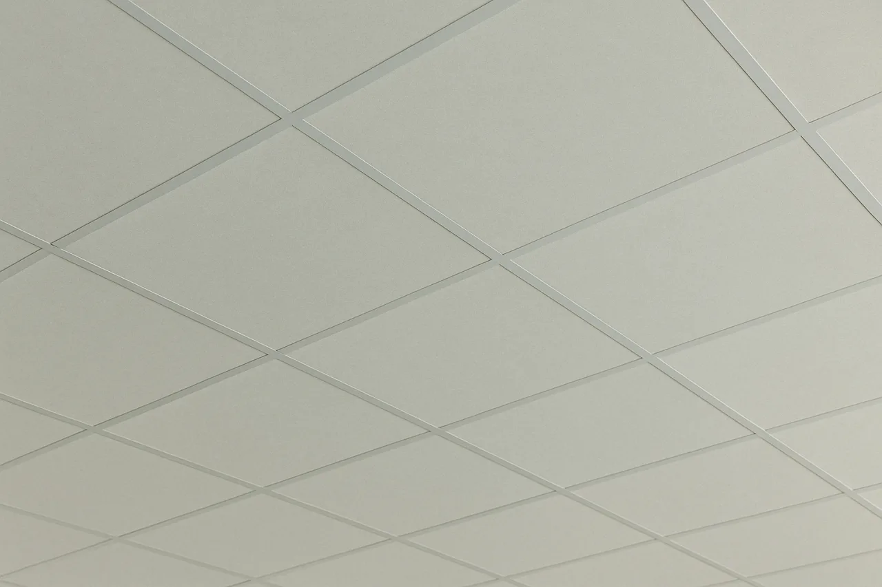 A square acoustic panel with a rough texture and crisscrossing fibers, forming a grid-like pattern. The panel has a natural, raw appearance with soft, neutral tones on a clean white background.