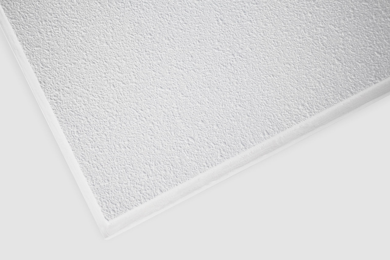 A close-up view of the corner of a white, textured acoustic ceiling tile, showing its rough, slightly bumpy surface and clean, straight edges.