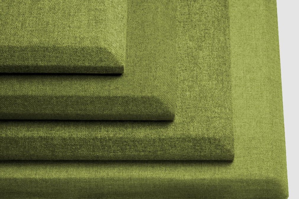 Four rectangular green acoustic sound panels of different sizes are stacked on top of each other, arranged in a stepped pattern against a plain light background.